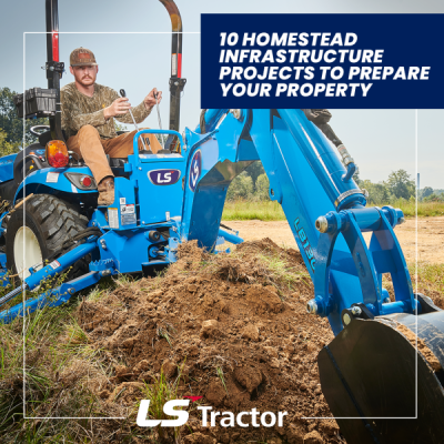 Compact tractor moving soil for drainage work